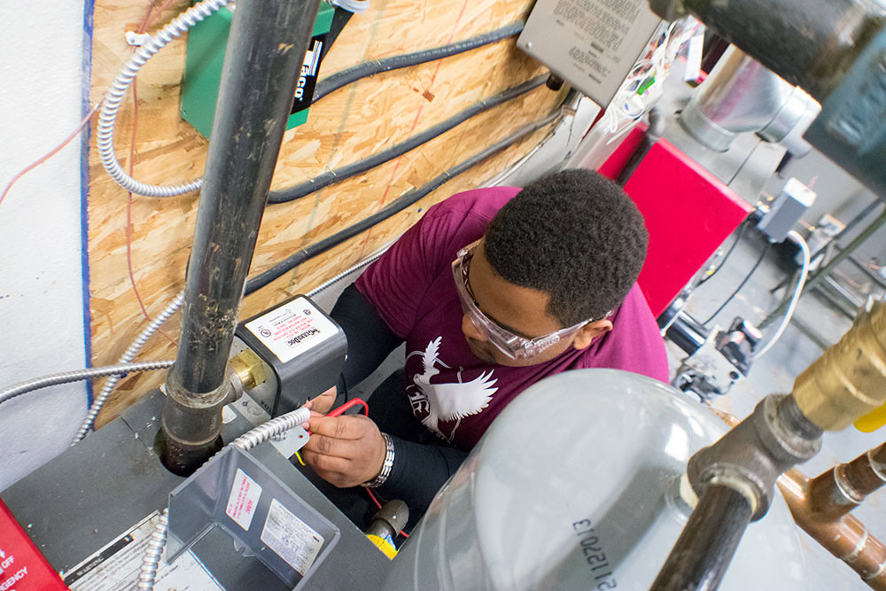 HVAC technician working on a unit