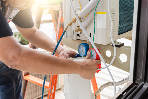 HVAC technician performing winter maintenance checklist with professional equipment and tools